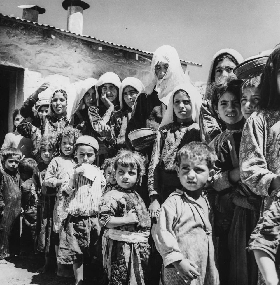 Palestinian refugees from Israel form a queue by the food tent in their camp in Amman, Jordan in 1955. (Three Lions / Getty Images)