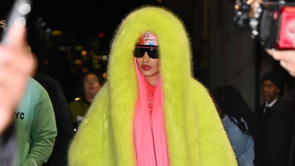 Minaj left the taping in a second Vauthier coat in neon lime green. - James Devaney/Getty Images