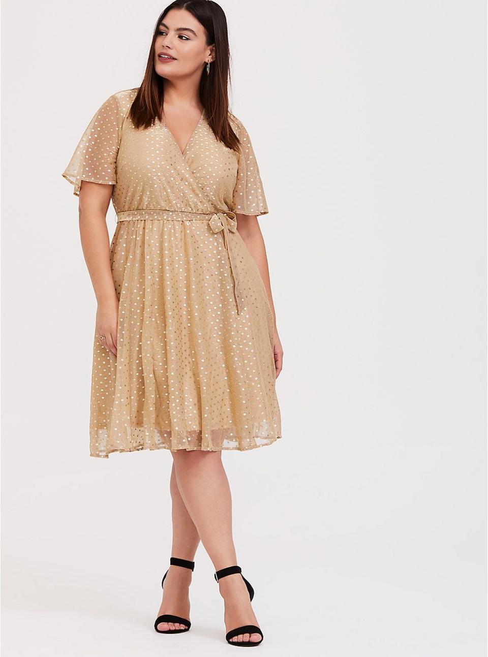 <p>torrid.com</p><p><strong>$51.67</strong></p><p><a href="https://go.redirectingat.com?id=74968X1596630&url=https%3A%2F%2Fwww.torrid.com%2Fproduct%2Fgold-metallic-polka-dot-mesh-wrap-dress%2F12141767.html&sref=https%3A%2F%2Fwww.goodhousekeeping.com%2Fholidays%2Fg29954145%2Fplus-size-new-years-dresses%2F" rel="nofollow noopener" target="_blank" data-ylk="slk:Shop Now;elm:context_link;itc:0;sec:content-canvas" class="link ">Shop Now</a></p><p>A basic wrap dress gets a sweet upgrade for New Year's Eve with a mesh overlay covered in metallic gold polka dots. </p>