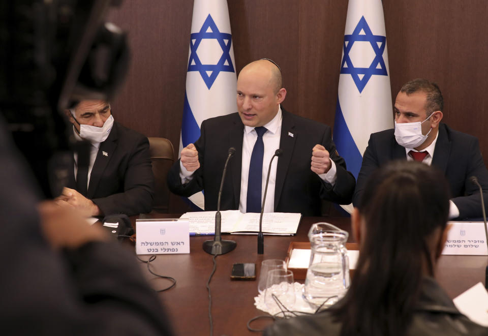 Israeli Prime Minister Naftali Bennett, center, chairs a weekly cabinet meeting, at the prime minister's office in Jerusalem, Sunday, Dec. 5, 2021. Bennett on Sunday urged world powers to take a hard line against Iran in negotiations to curb the country's nuclear program, as his top defense and intelligence officials headed to Washington amid the flailing talks. (Gil Cohen-Magen/Pool via AP)