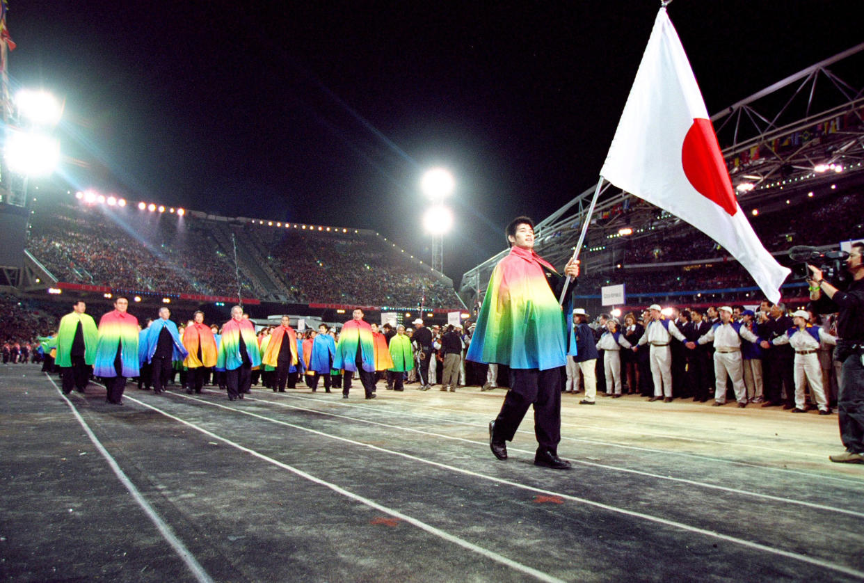 15 Sep 2000:  Flag Bearer and Judo competitor Kosei Inoue leads the Japan Olympic Team round during the Opening Ceremony of the Sydney 2000 Olympic Games at the Olympic Stadium in Homebush Bay, Sydney, Australia. Mandatory Credit: Jed Jacobsohn /Allsport