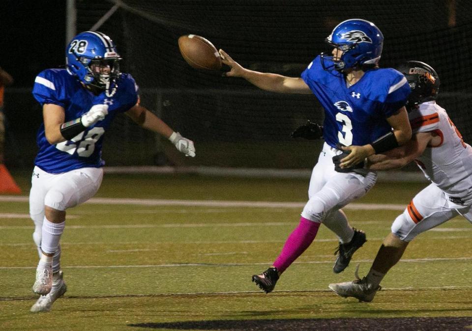 Olathe Northwest quarterback Zayne Wilson pitches the ball to Manny Melendez during a recent game against Shawnee Mission Northwest.