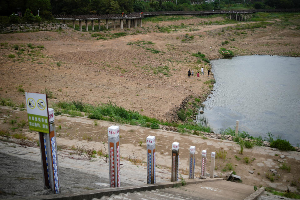 Water level poles emerge after waters receded in a reservoir, amid hot temperatures, while many regions from southwest to east of the country along the Yangtze river have been experiencing weeks of record-breaking heatwave in Changxing, Zhejiang province, China, August 20, 2022. REUTERS/Aly Song