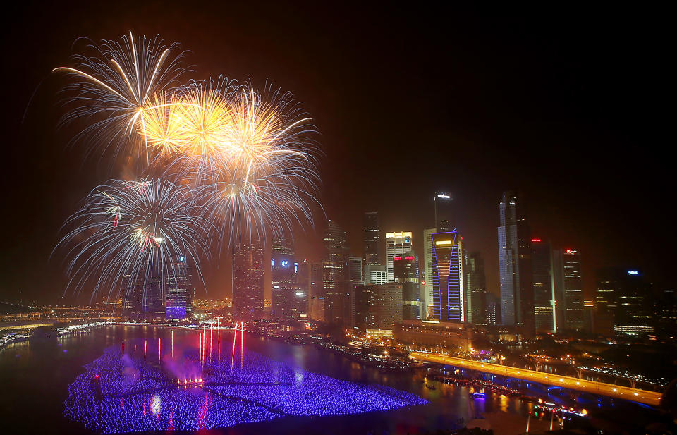 Fireworks explode over the financial district at midnight, Wednesday, Jan. 1, 2014 in Singapore. Celebrations started on New Year's Eve where concerts were held and thousands gathered on the streets to usher in the Year 2014. (AP Photo/Wong Maye-E)