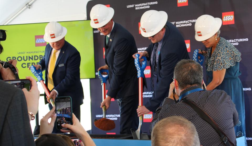 Virginia Governor Glenn Youngkin scoops up the first pile of dirt at the LEGO Manufacturing Richmond groundbreaking ceremony in Chester, Va. on April 13, 2023.