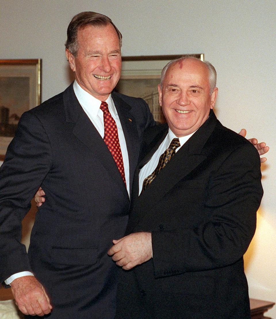 Picture taken on September 9, 1999 shows former US President George Bush (L) and former Soviet leader Mikhail Gorbachev at the German presidential Bellevue Palace in Berlin (DPA/AFP via Getty Images)