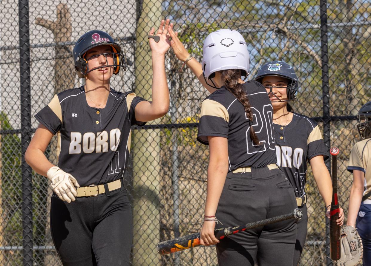 Point Boro’s Emily Ehrman gets a high five from Arden Schatzman after scoring her team’s sixth run of game. Point Pleasant Borough Softball defeats Freehold Borough 9-5 in Point Pleasant on May 1, 2024.