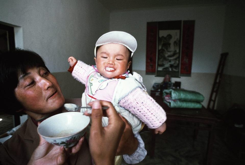 The original caption of this 1994 photo accompanying an article on China’s one-child policy was: ‘A baby is fed by its mother. The child is probably never to have a sister or brother.’ <a href="https://www.gettyimages.com/detail/news-photo/baby-is-fed-by-its-mother-the-child-is-probably-never-to-news-photo/158661290?adppopup=true" rel="nofollow noopener" target="_blank" data-ylk="slk:Peter Charlesworth/LightRocket via Getty Images;elm:context_link;itc:0;sec:content-canvas" class="link ">Peter Charlesworth/LightRocket via Getty Images</a>