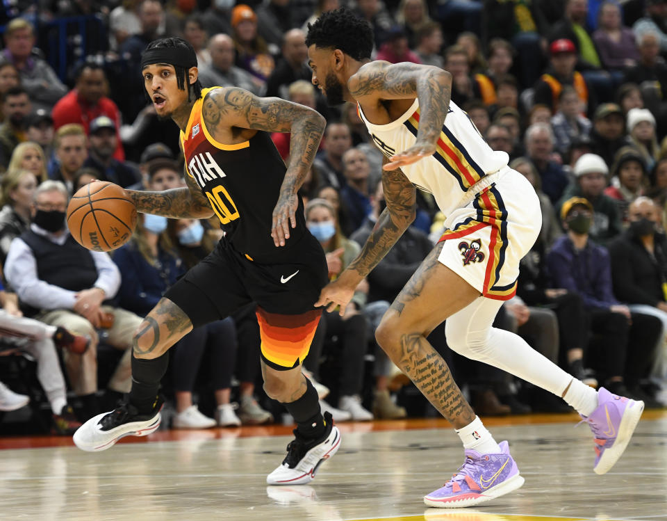 New Orleans Pelicans guard Nickeil Alexander-Walker, right, defends Utah Jazz guard Jordan Clarkson (00) during the first half of an NBA basketball game Friday, Nov. 26, 2021, in Salt Lake City. (AP Photo/Alex Goodlett)