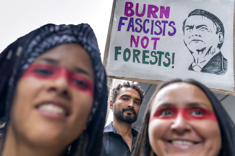 People protest in front of the Consulate General of Brazil in Geneva, Switzerland, Friday, Aug. 23, 2019 to denounce the words of President Bresil Jair Bolsonaro and the many fires in the forest Amazon. (Martial Trezzini/Keystone via AP)