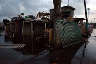 <p>A dog is seen during the nightfall at a house destroyed by the passage of Hurricane Maria in Juana Matos, Catano, Puerto Rico, on September 26, 2017. (Photo: Hector Retamal/AFP/Getty Images) </p>