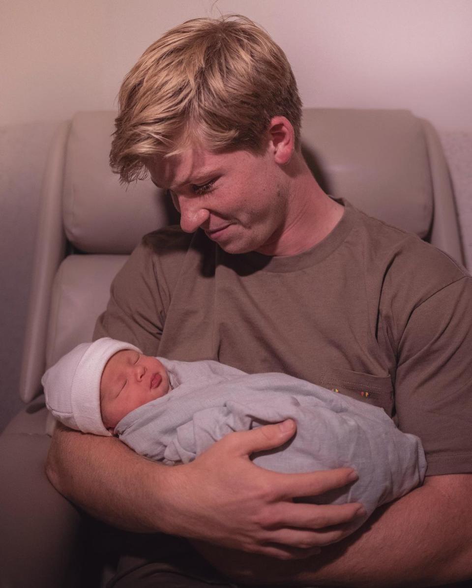 Robert Irwin holding his newborn niece, Grace Warrior Irwin Powell