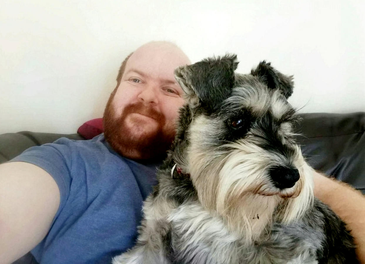 Clayton posed with his schnauzer in his advert. (SWNS)