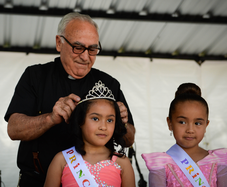 Father Celestino Gutiérrez crowns a princess during the St. Jude Church Hispanic Festival in 2016.