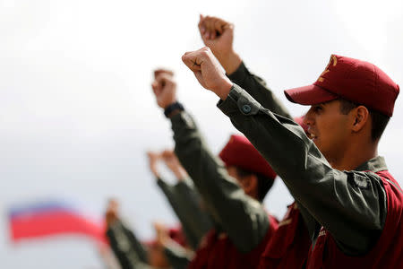 Soldiers shouts slogans as they stand in formation before the start of a ceremony to kick off the distribution of security forcers and voting materials to be used in the upcoming presidential elections, at Fort Tiuna military base in Caracas, Venezuela May 15, 2018. REUTERS/Carlos Jasso