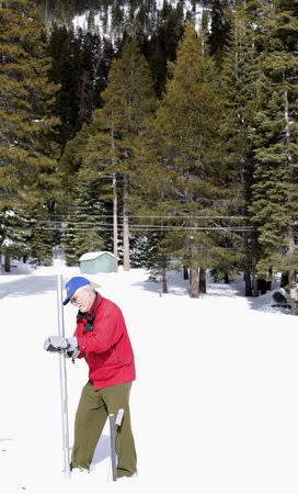 Frank Gehrke takes a snowpack measurement during the first snow survey of winter conducted by the California Department of Water Resources in Phillips, California, December 30, 2015. REUTERS/Fred Greaves