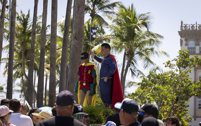 Two demonstrators are dressed as comic book superheroes