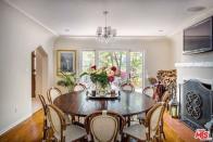 <p>The dining room also features a fireplace and wood floors. (Realtor.com) </p>