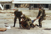 <p>Members of the Florida National Guard subdue a man outside the Cutler Ridge shoe store after the guard found the store wide open. The unidentified man, carrying a firearm, was wrestled to the ground after guard members though he was looting the store. There was no evidence he was looting. (AP Photo/Lynne Sladky) </p>