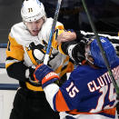 Pittsburgh Penguins center Evgeni Malkin roughs up Islanders right wing Cal Clutterbuck Saturday May 22, 2021, at the Nassau Veterans Memorial Coliseum in Uniondale, NY. (Peter Diana/Pittsburgh Post-Gazette via AP)