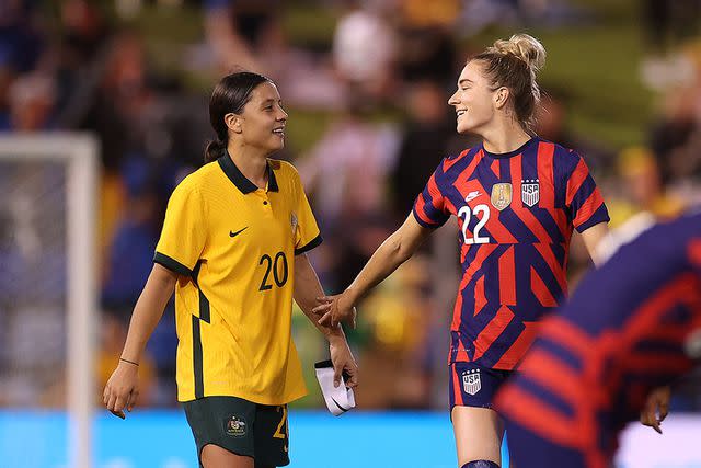 <p>Mark Kolbe/Getty </p> Sam Kerr and Kristie Mewis compete against each other at the International Friendly series in November 2021