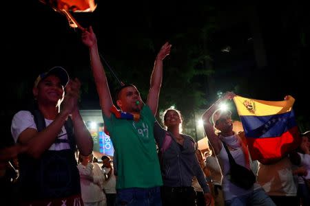 Opposition supporters react while waiting for results of the unofficial plebiscite against President Nicolas Maduro's government and his plan to rewrite the constitution, in Caracas, Venezuela July 16, 2017. REUTERS/Marco Bello