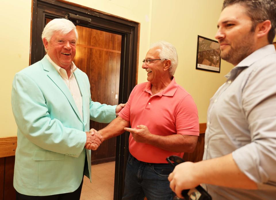 Longtime Stoughton High School head football coach Greg Burke, left, receives congratulations at his retirement party at Stoughton VFW Post 1645 on Sunday, May 21, 2023.