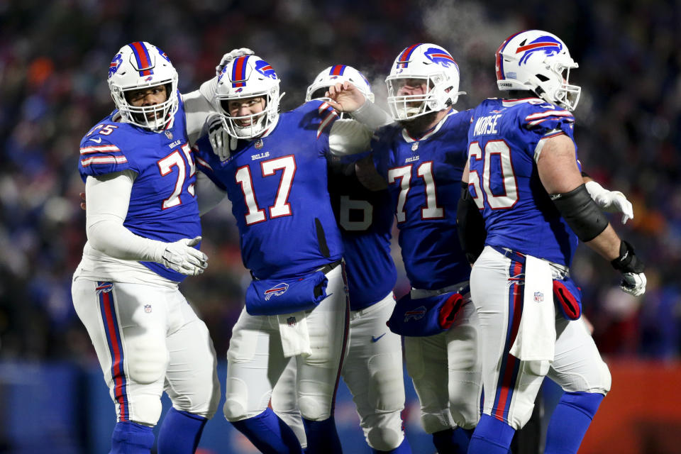 Buffalo Bills quarterback Josh Allen (17) celebrates after wide receiver Gabriel Davis (13) scores a touchdown during the second half of an NFL wild-card playoff football game against the New England Patriots, Saturday, Jan. 15, 2022, in Orchard Park, N.Y. (AP Photo/Joshua Bessex)