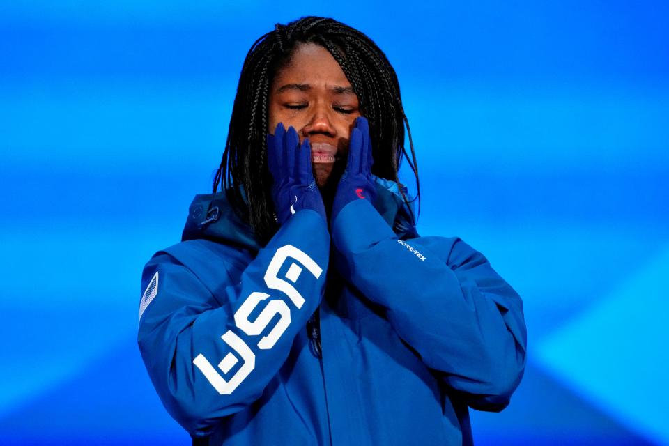 Speedskater Erin Jackson stands on the podium after winning the gold medal in the 500 meters at the 2022 Beijing Olympics.