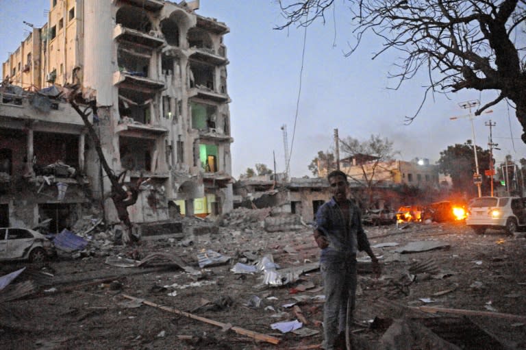 A man stands next to the Ambassador Hotel, after Somalia's Al-Qaeda-linked Shabaab on June 1, 2016 launched a deadly attack on the hotel in Mogadishu