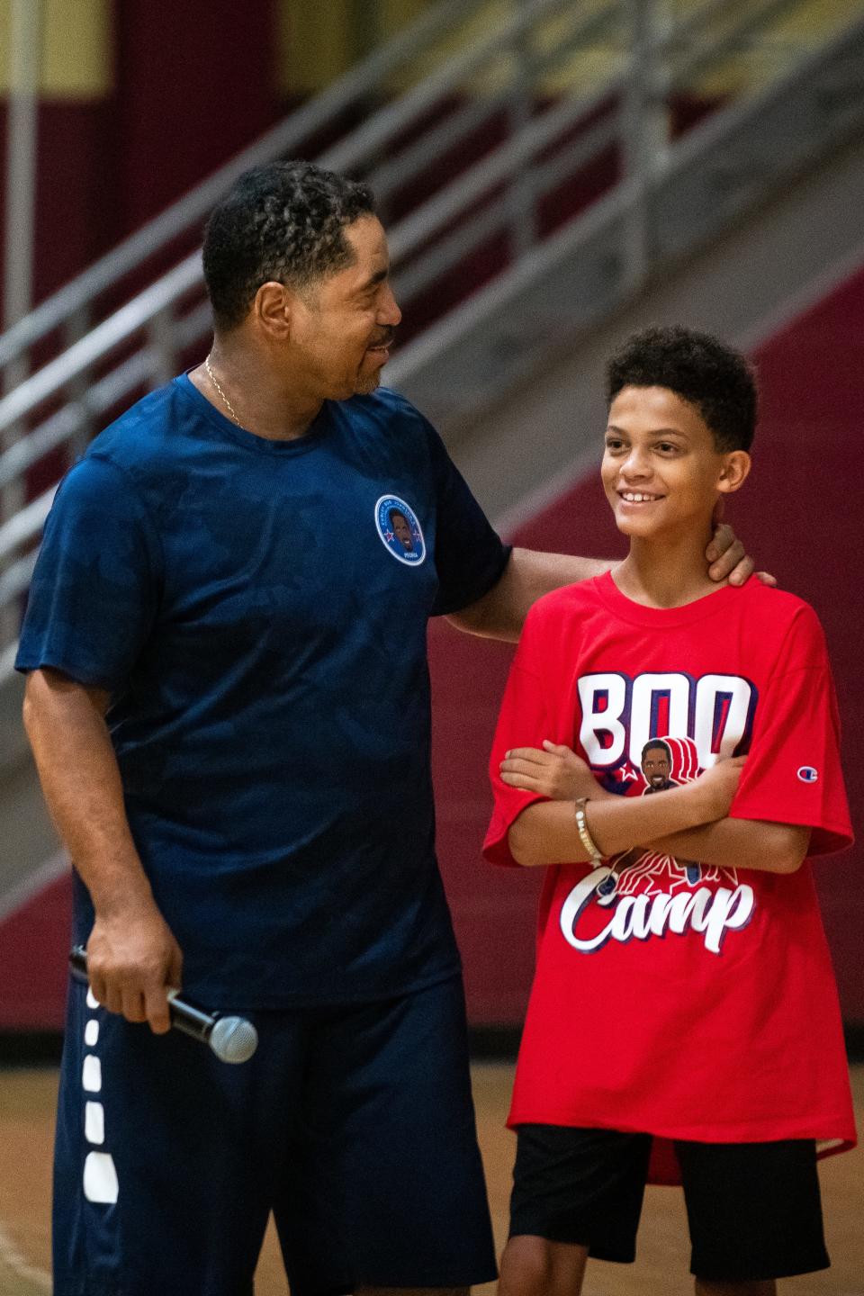 Curley "Boo" Johnson (left) assigns a camper to a team during his Skills for Life camp at Dunlap High School on Monday, August 2, 2021.