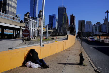 A homeless man rests on the street in New York January 4, 2016. REUTERS/Lucas Jackson