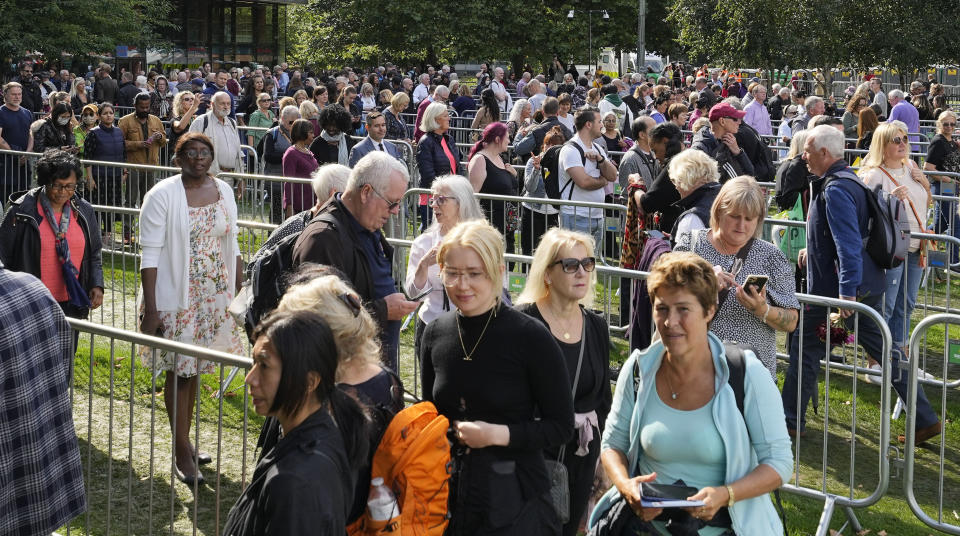 People queue at the start of the more than four miles long line near Tower Bridge to pay their respect to the late Queen Elizabeth II during the Lying-in State, in Westminster Hall in London, Thursday, Sept. 15, 2022. The Queen will lie in state in Westminster Hall for four full days before her funeral on Monday Sept. 19. (AP Photo/Martin Meissner)