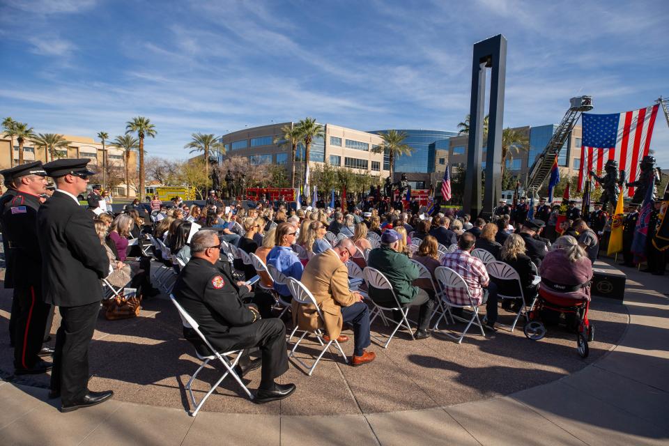 Attendees bow their heads and listen as the names of 156 fallen firefighters who have died in Arizona since 1902 are read during the Arizona Fallen Firefighters and Emergency Paramedics Memorial at Wesley Bolin Memorial Plaza in Phoenix, Ariz. on Sunday, Jan. 16, 2022. There were 14 names added to the list this year.