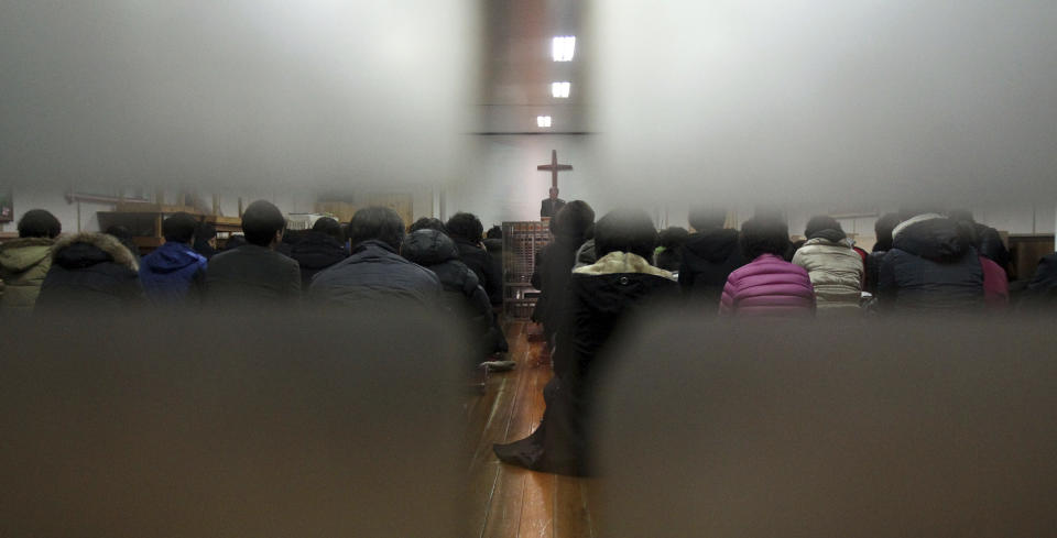 Members from Jincheon Jungang Presbyterian Church attend a service at their church in Jincheon, South Korea, Monday, Feb. 17, 2014. A bombing that killed three South Koreans and an Egyptian driver on the Sinai Peninsula targeted a bus filled with Korean members from the church who had saved for years to visit sites mentioned in the Bible on their church’s 60th anniversary, officials said Monday. (AP Photo/Yonhap, Kim Hyung-woo) KOREA OUT