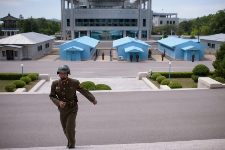 The truce village of Panmunjom, with its blue huts and concrete demarcation line that runs through the Demilitarized Zone that divides North and South Korea