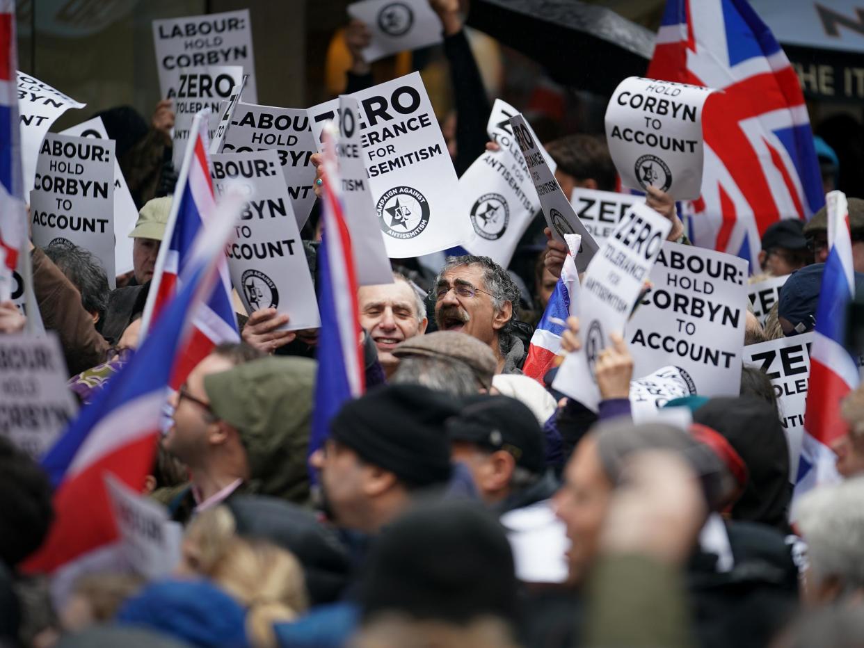 Protesters from the Campaign Against Antisemitism demonstrate and listen to speakers outside the Labour Party headquarters on 8 April: Getty