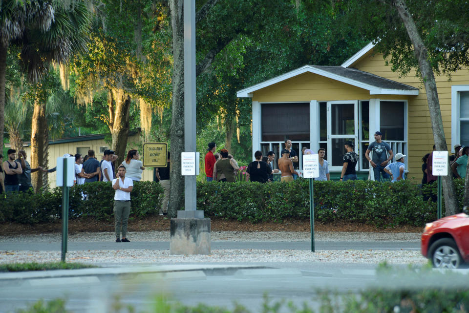 <p>People gather as police conduct questioning near Pulse nightclub, where people were killed by a gunman in a shooting rampage in Orlando, Florida June 12, 2016. (REUTERS/Kevin Kolczynski) </p>