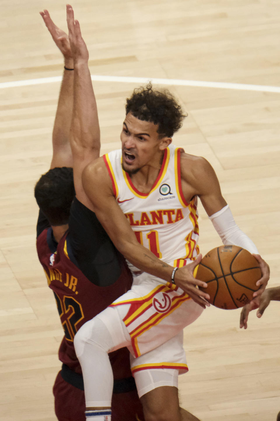 Atlanta Hawks guard Trae Young (11) drives past Cleveland Cavaliers forward Larry Nance Jr. (22) during the first half of an NBA basketball game on Saturday, Jan. 2, 2021 in Atlanta. (AP Photo/Ben Gray)