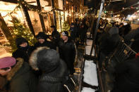 A long line of people brave the cold as they wait to be the first in Illinois to purchase recreational marijuana at Sunnyside dispensary Wednesday, Jan. 1, 2020, in Chicago. (AP Photo/Paul Beaty)