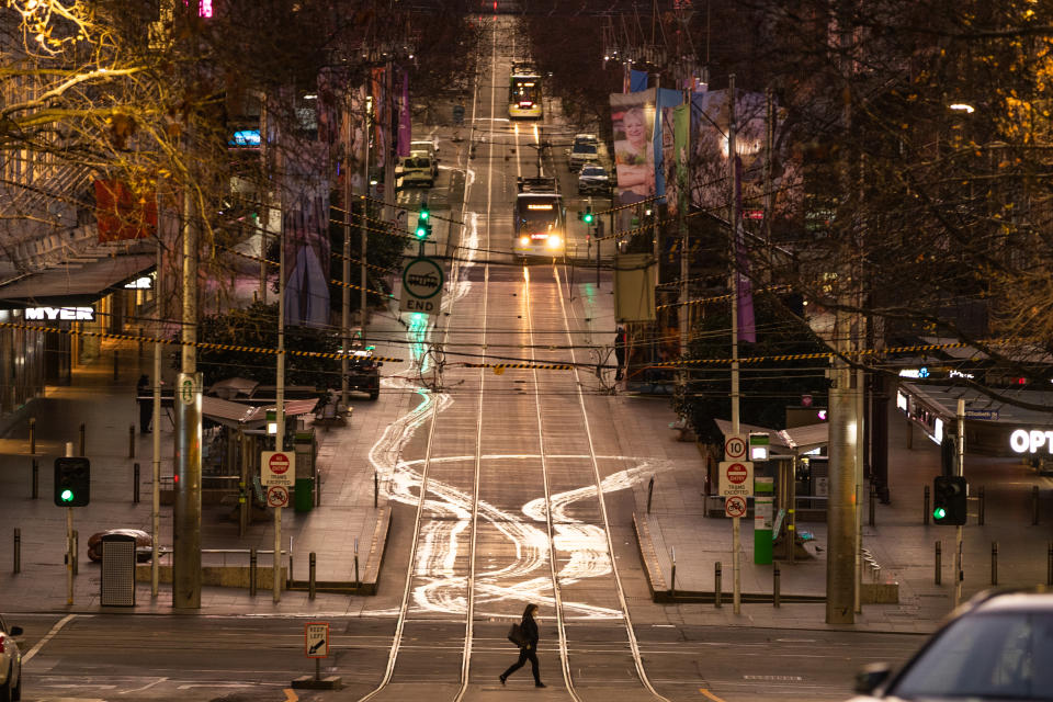 A general view of Bourke Street as a lone Pedestrian crosses the road on August 06, 2020 in Melbourne, Australia.