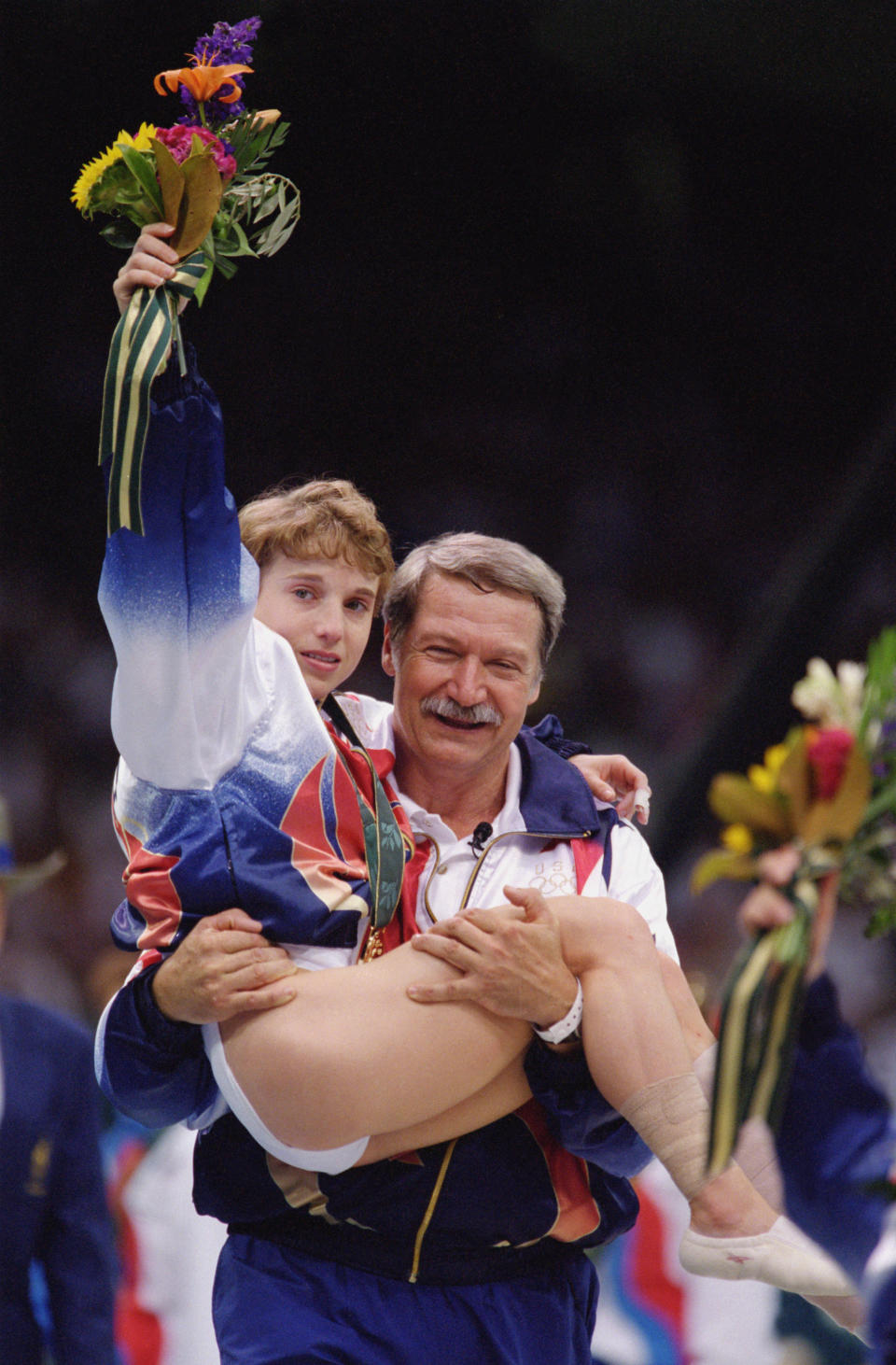 ATLANTA - JULY 23:  Coach Bela Karolyi carries an injured yet triumphant Kerri Strug of the United States after she received her gold medal in the Womens Team Gymnastics competition at the 1996 Olympic Games on July 23, 1996 at the Georgia Dome in Atlanta, Georgia.  (Photo by Doug Pensinger/Getty Images)