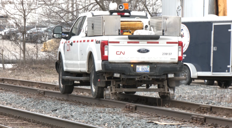 A truck from CN navigates rails near the location where creosote dripped into the Grand River in Lansing. (WLNS)