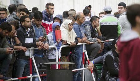 Migrants wait in front of the State Office for Health and Social Affairs (LaGeSo), in Berlin, Germany, September 3, 2015. REUTERS/Hannibal Hanschke