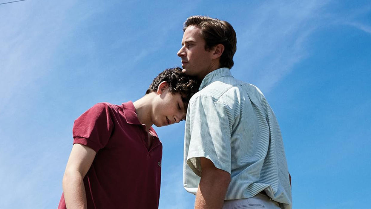  Timothée Chalamet leans his head on Armie Hammer's shoulder against a blue sky. 