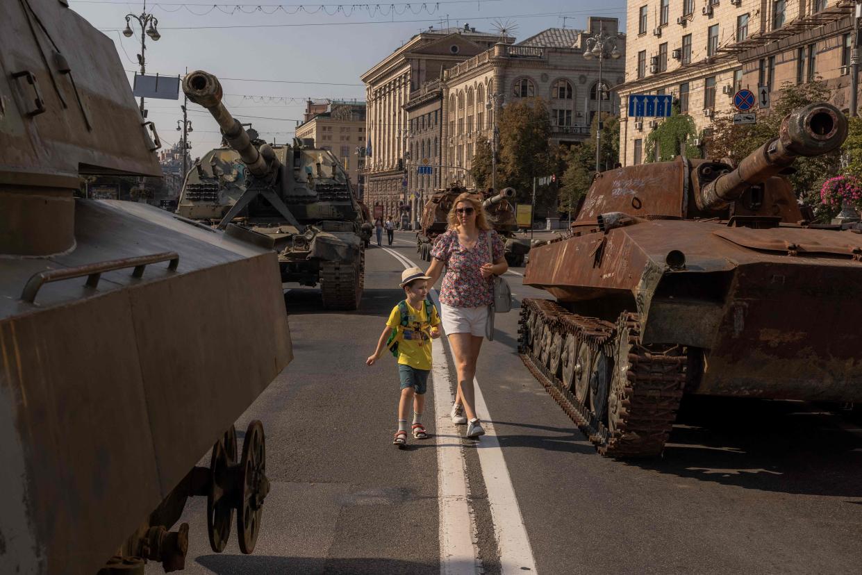 August 21, 2023: A woman and a young boy look at destroyed Russian armored military vehicles on display in Kyiv ahead of Ukraine's Independence Day, amid the Russian invasion of Ukraine.