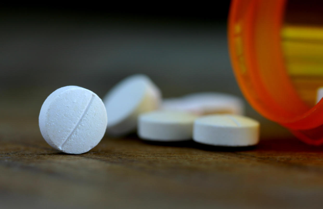 Aspirin tablets and a pill container.