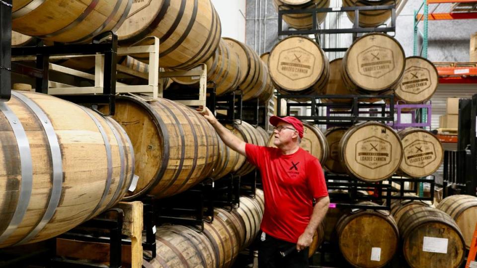 Steve Milligan, founder, president and chief distiller at Loaded Cannon Distillery, Suite 110 of the Gatewood Corporate Center, 3115 Lakewood Ranch Blvd., looks 6/28/2022 at barrels of aging spirits. 