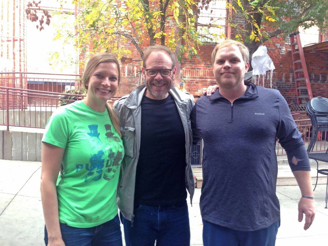 Brooke Russell, left, and Travis Russell, right, are pictured with food celebrity Alton Brown, who likes to visit Public at the Brickyard when he’s in town for shows.