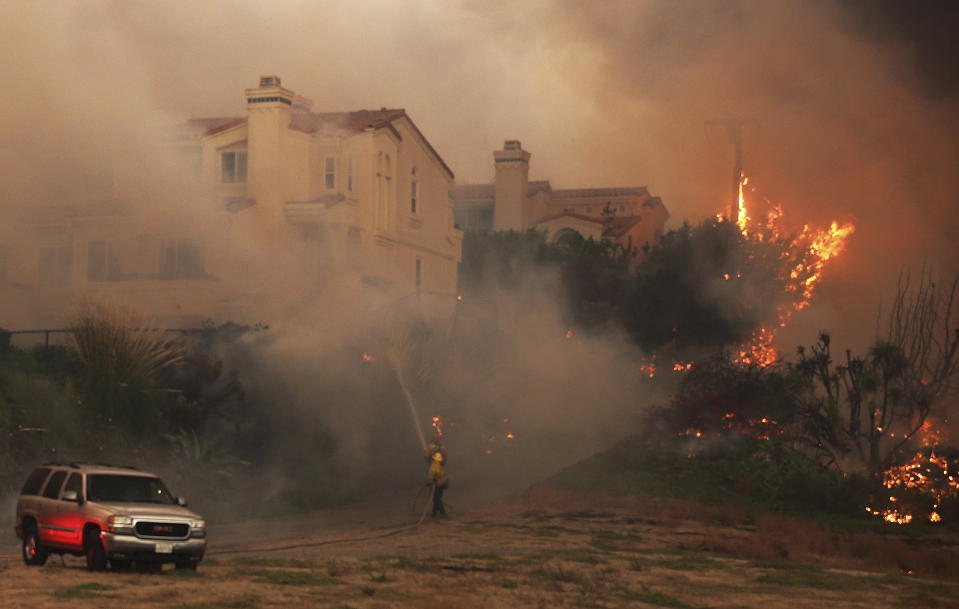 <p>Firefighters struggle to keep flames from a condominium complex on Pacific Coast Highway in the Point Dume area of Malibu, Calif., Friday, Nov. 9, 2018.<br>Known as the Woolsey fire, it has consumed thousands of acres and destroyed multiple homes.<br>(Photo from Reed Saxton, AP) </p>